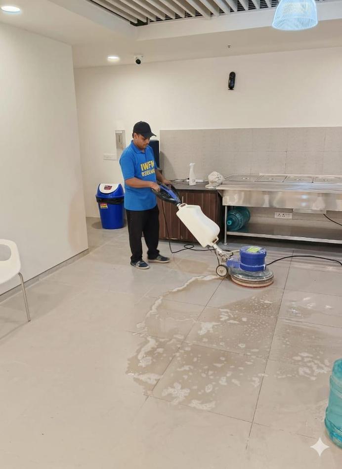 IWFM staff operating a floor scrubbing machine